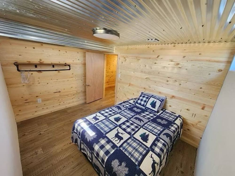 Knotty pine bedroom with a queen bed at Cloverdale House