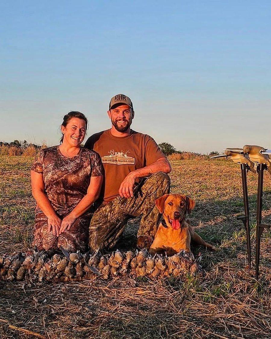 Steven Freese and his wife with their dog behind a morning limit of doves