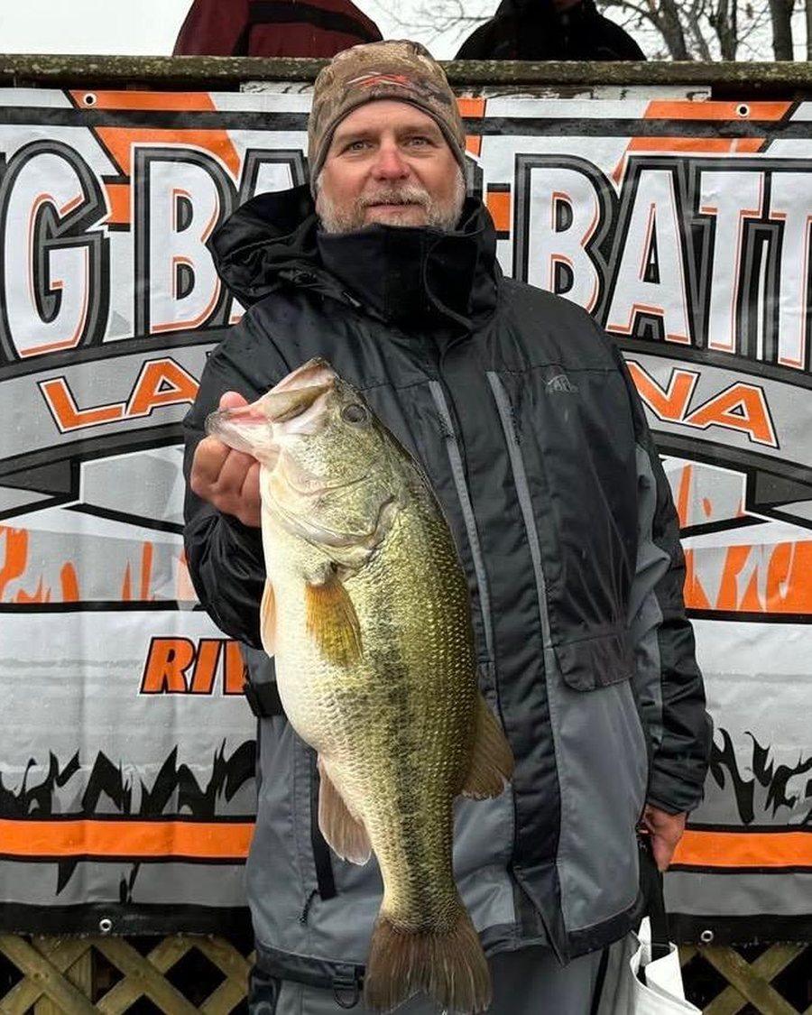 Tom Toews holding up a largemouth bass